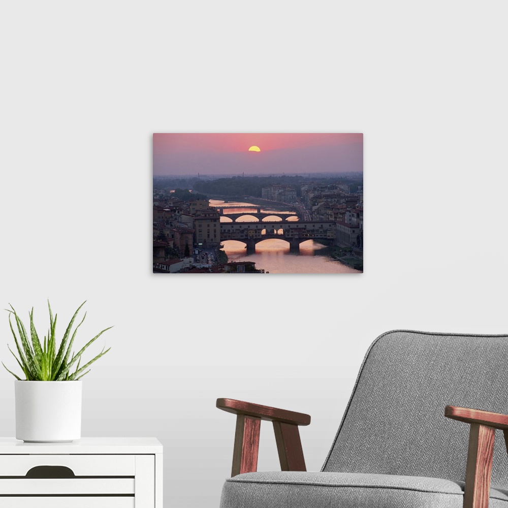 A modern room featuring Ponte Vecchio over the River Arno at sunset in the city of Florence, Tuscany, Italy