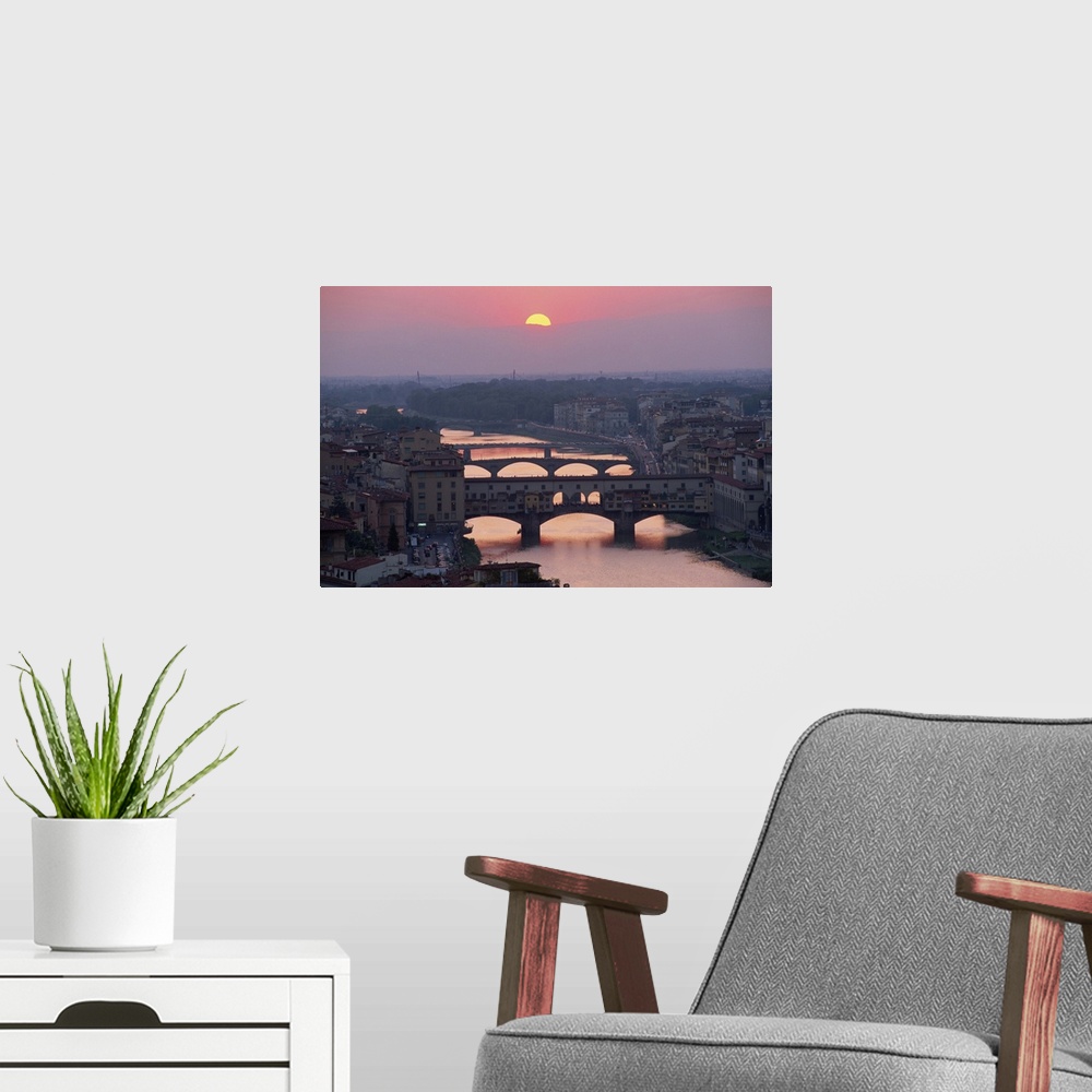 A modern room featuring Ponte Vecchio over the River Arno at sunset in the city of Florence, Tuscany, Italy