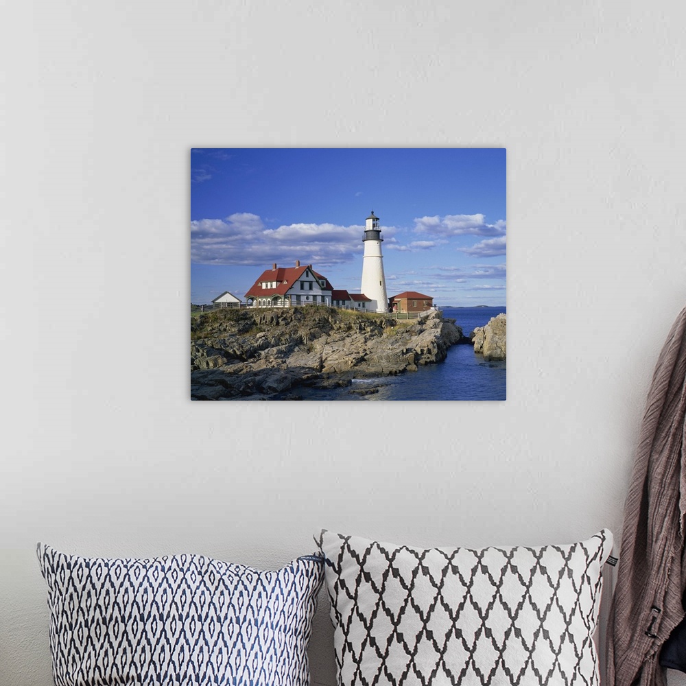 A bohemian room featuring Portland Head lighthouse on rocky coast at Cape Elizabeth, Maine, New England
