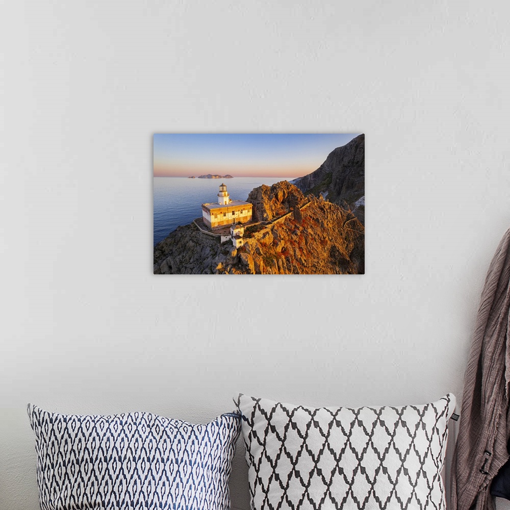 A bohemian room featuring Aerial view of Punta della Guardia lighthouse on top of a cliff on the island of Ponza, lit from ...