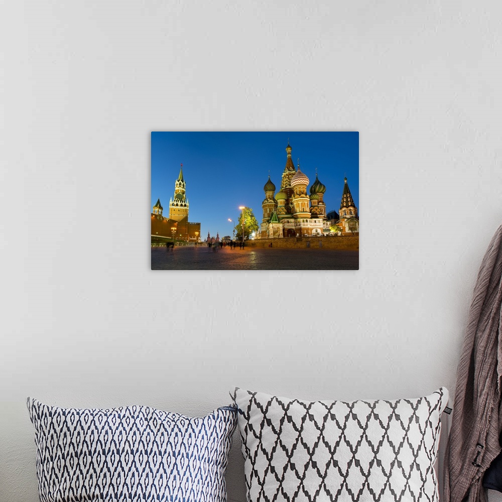 A bohemian room featuring Red Square, St. Basil's Cathedral and the Savior's Tower of the Kremlin lit up at night, Moscow, ...