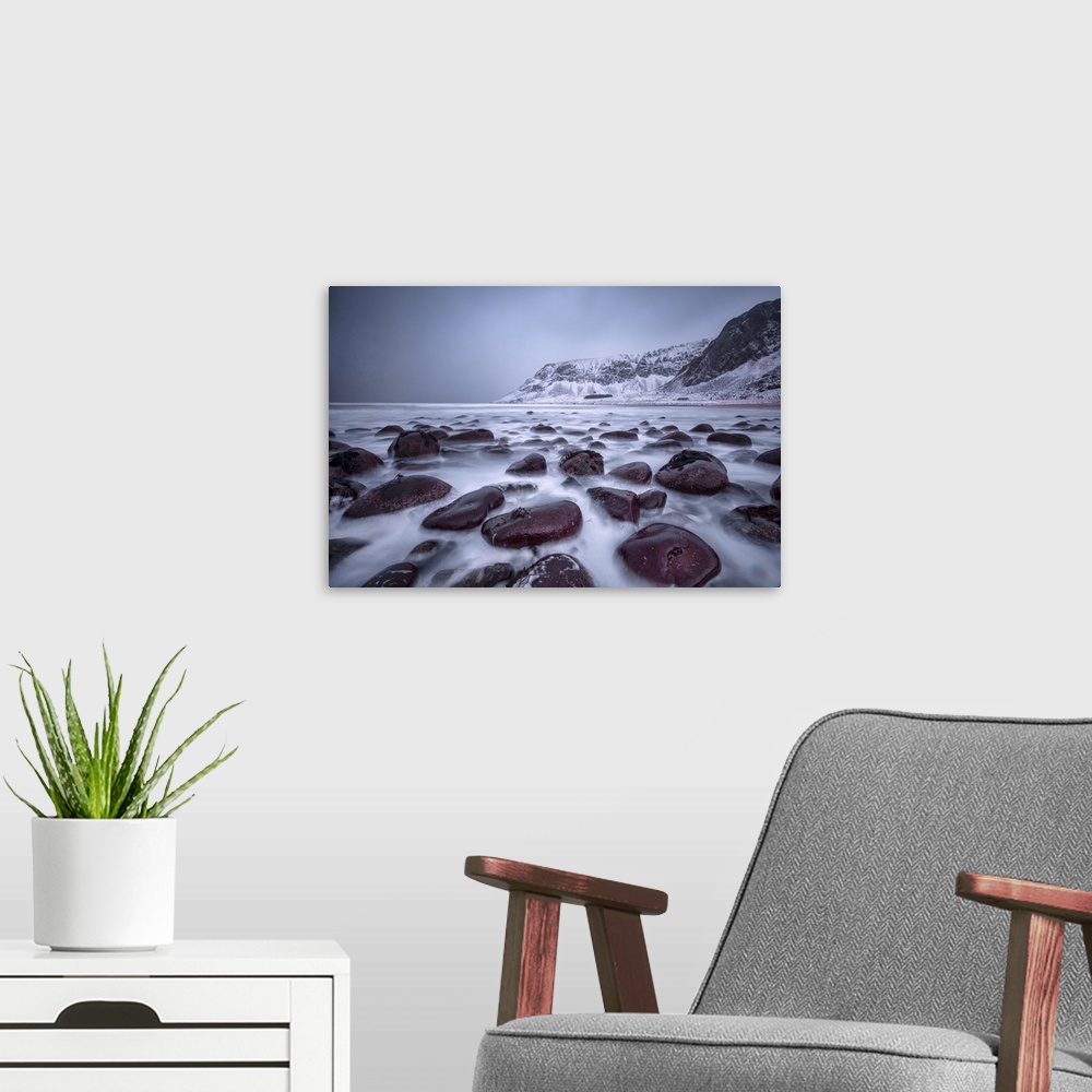 A modern room featuring Rocks on the beach modeled by the wind surround the icy sea, Unstad, Lofoten Islands, Arctic, Nor...
