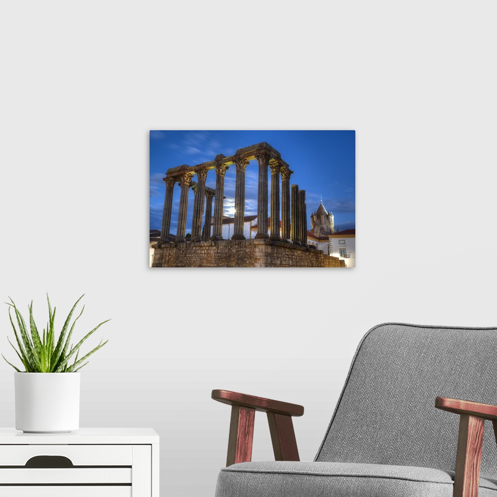 A modern room featuring Roman Temple in foreground, Evora Cathdral in the background, Evora, UNESCO World Heritage Site, ...