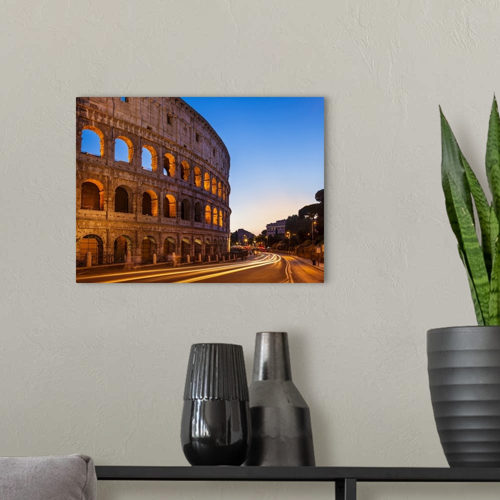 A modern room featuring Rome Colosseum (Flavian Amphitheatre) at night with light trail, UNESCO World Heritage Site, Rome...