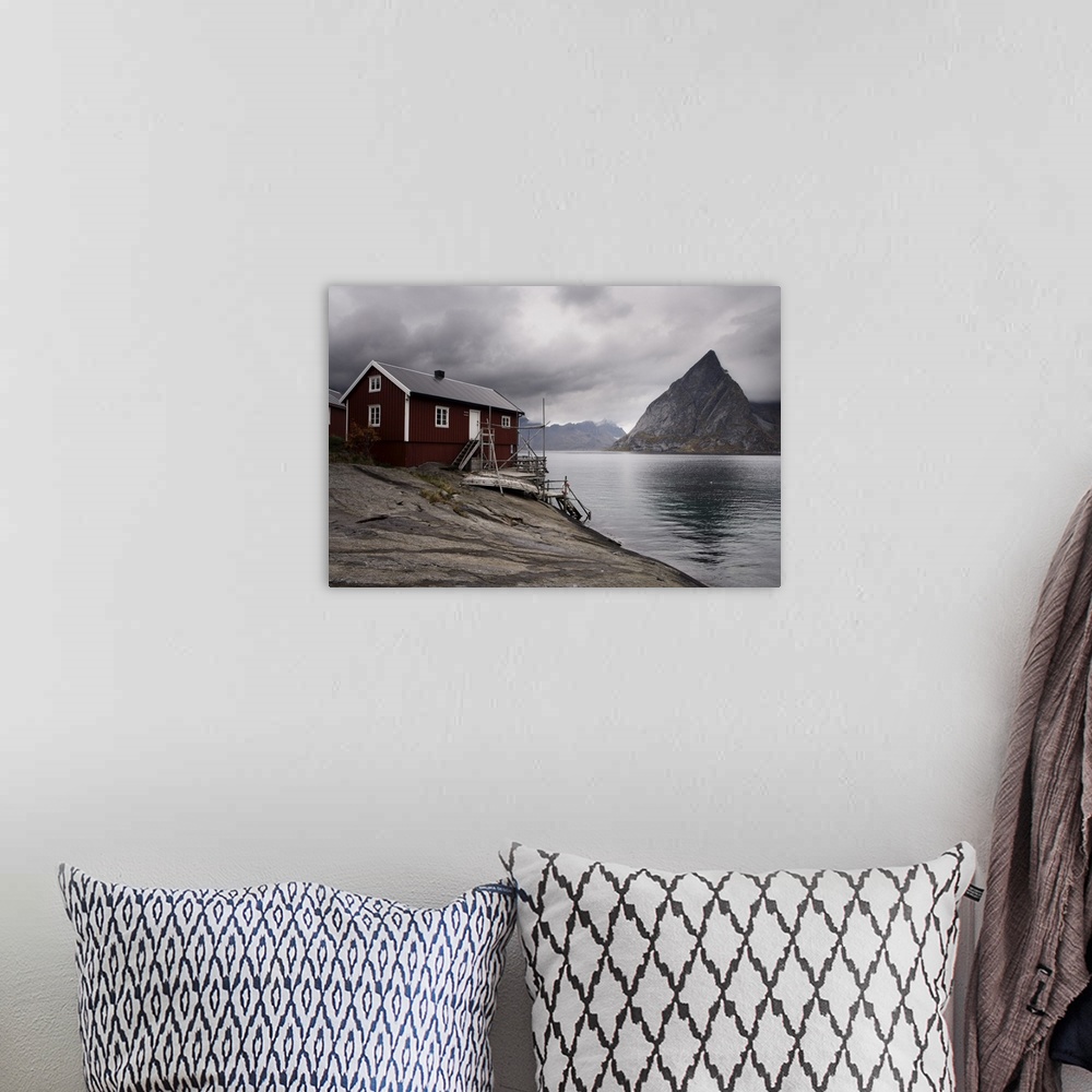 A bohemian room featuring Rorbuer (fishermen's huts) on fjord with mountains, Lofoten Islands, Norway, Scandinavia