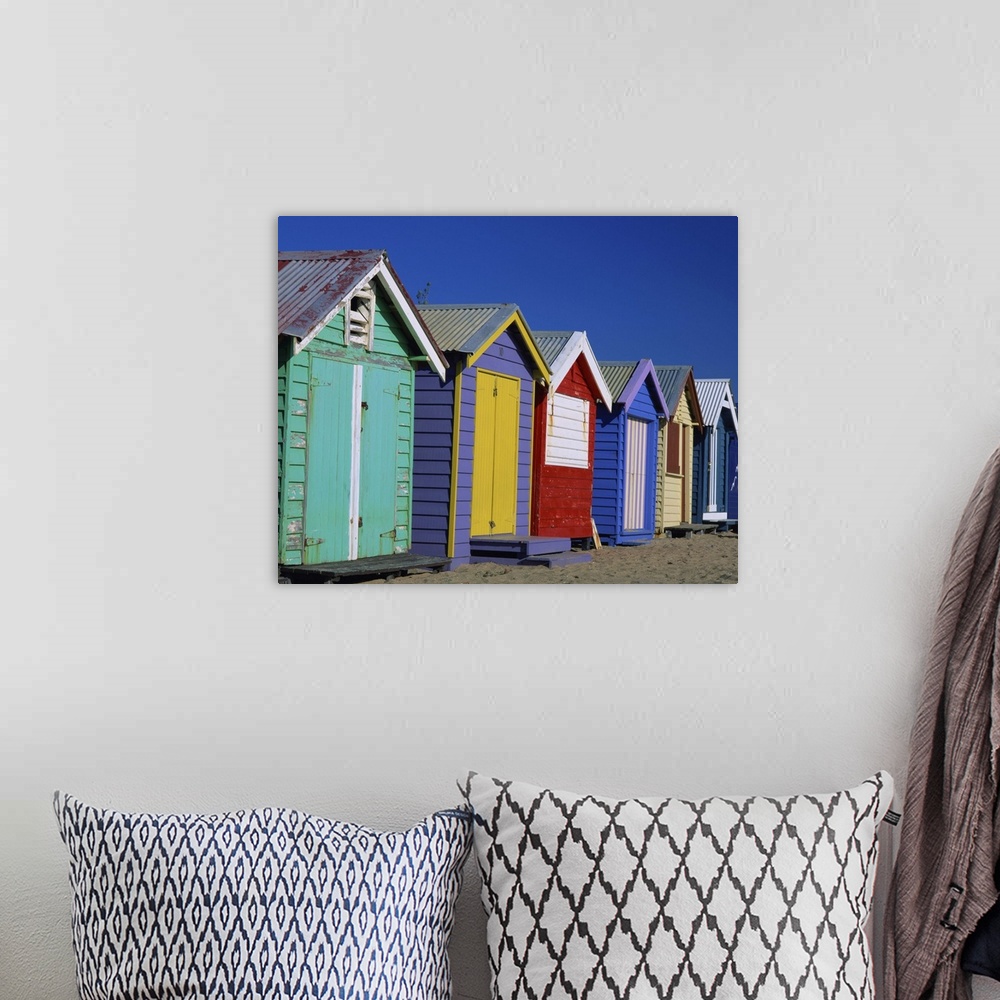 A bohemian room featuring Row of beach huts painted in bright primary colours, Brighton Beach, Victoria, Australia
