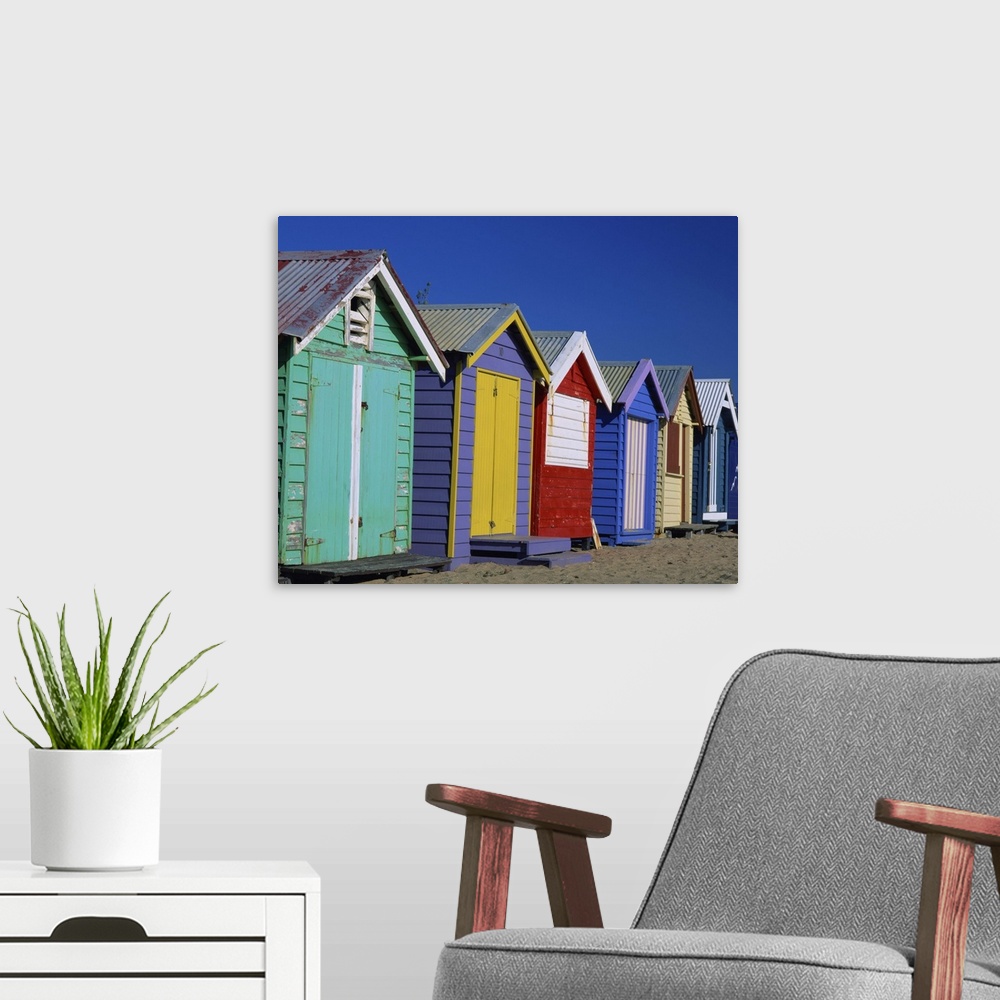 A modern room featuring Row of beach huts painted in bright primary colours, Brighton Beach, Victoria, Australia