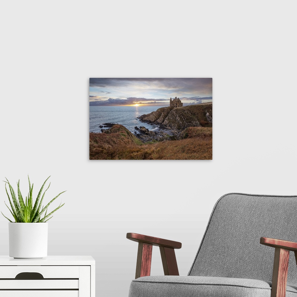 A modern room featuring Ruins of Dunskey Castle on rugged coastline at sunset, Portpatrick, Dumfries and Galloway, Scotla...