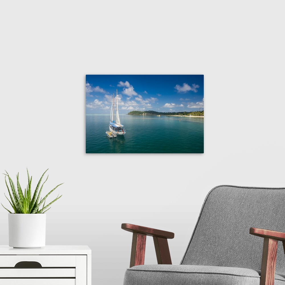 A modern room featuring Sailing boat anchoring on Mana Island, Mamanuca Islands, Fiji, South Pacific