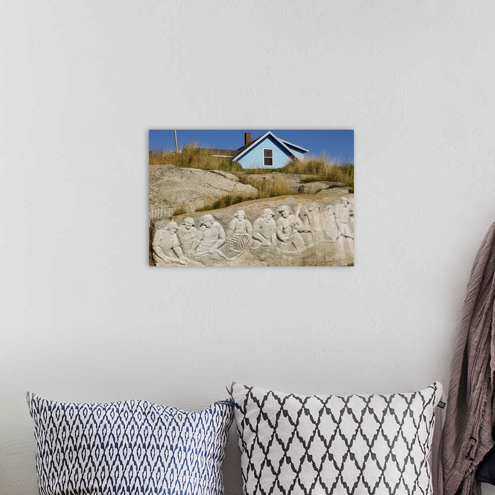A bohemian room featuring Sculpture of residents carved onto rock, at Peggys Cove, Nova Scotia, Canada