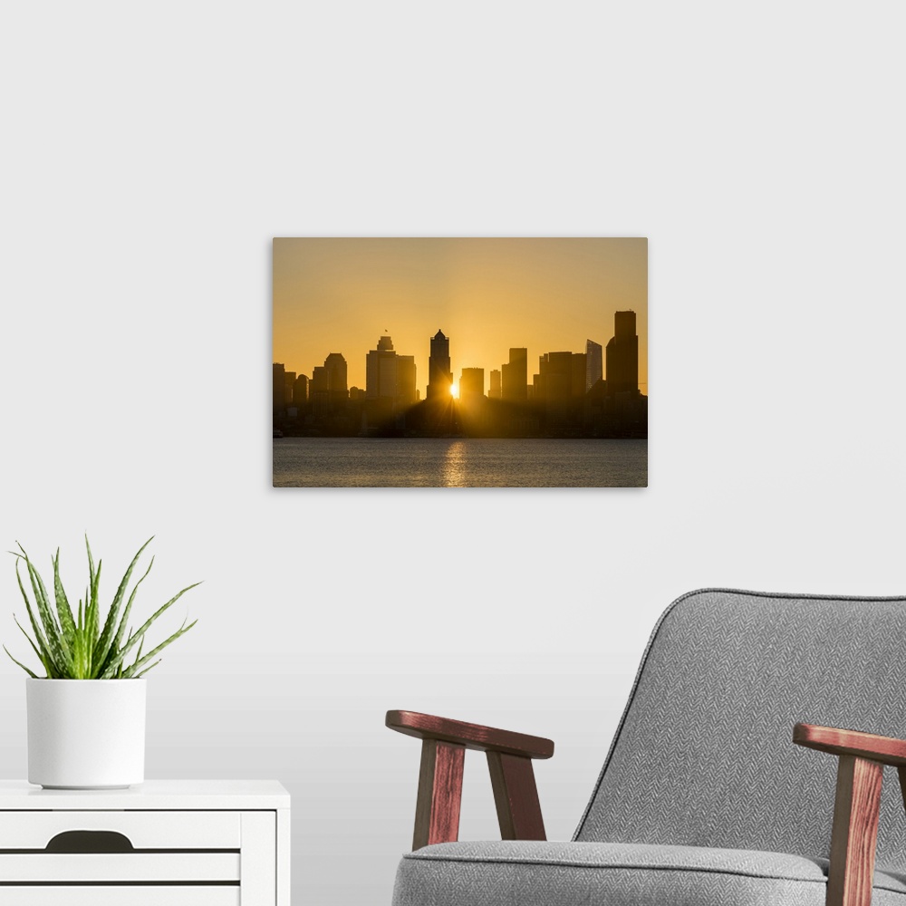 A modern room featuring Seattle skyline at sunrise, as seen from Alki Beach, Seattle, Washington State, United States of ...