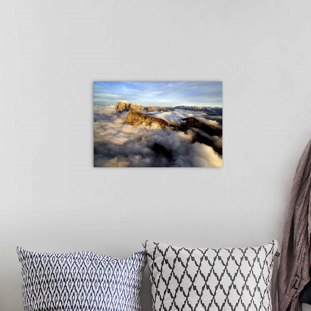 A bohemian room featuring Aerial shot from Seceda of Odle surrounded by clouds at sunset in the Dolomites, Val Funes, Trent...