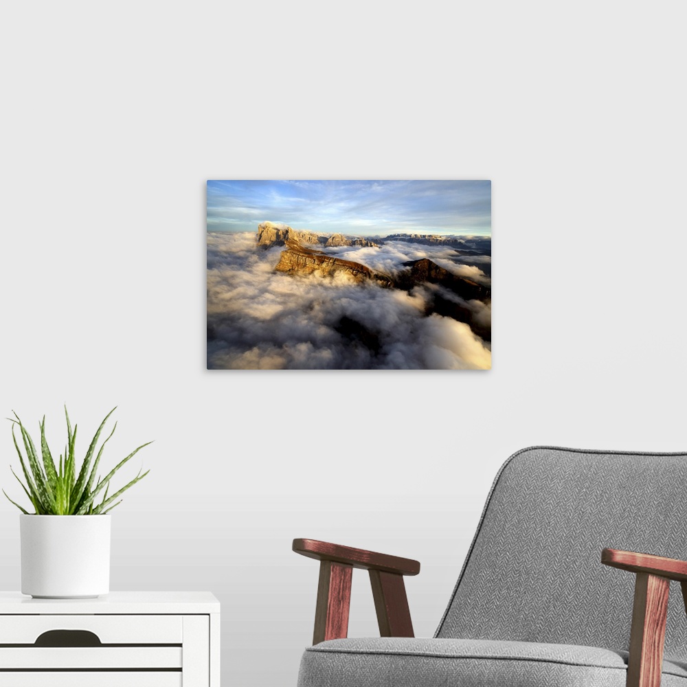 A modern room featuring Aerial shot from Seceda of Odle surrounded by clouds at sunset in the Dolomites, Val Funes, Trent...