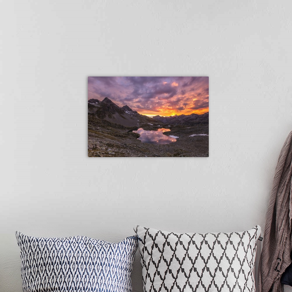 A bohemian room featuring Fiery sky at dawn reflected in Lai Ghiacciato framed by peaks, Val Ursaregls, Chiavenna Valley, V...