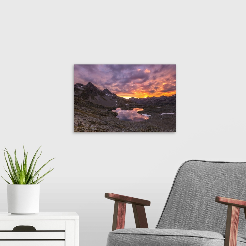 A modern room featuring Fiery sky at dawn reflected in Lai Ghiacciato framed by peaks, Val Ursaregls, Chiavenna Valley, V...