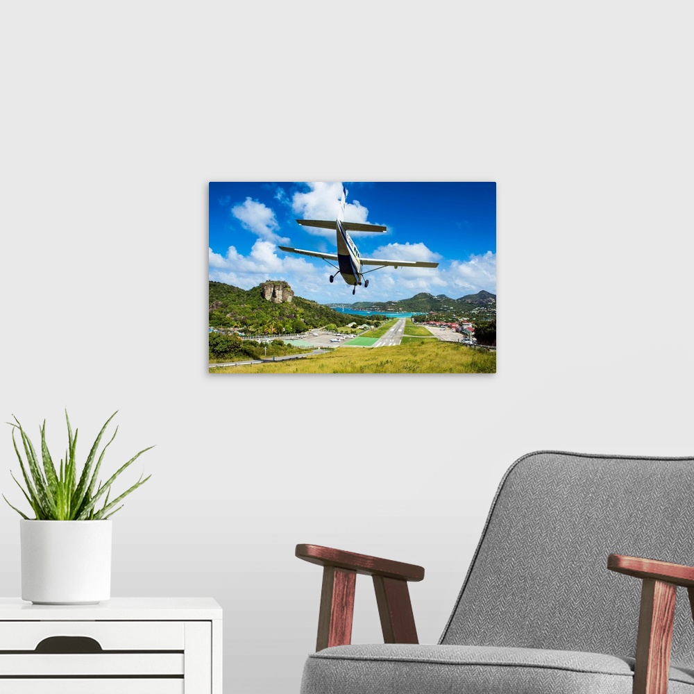 A modern room featuring Small airplane landing at the airport of St. Barth, Lesser Antilles, West Indies, Caribbean