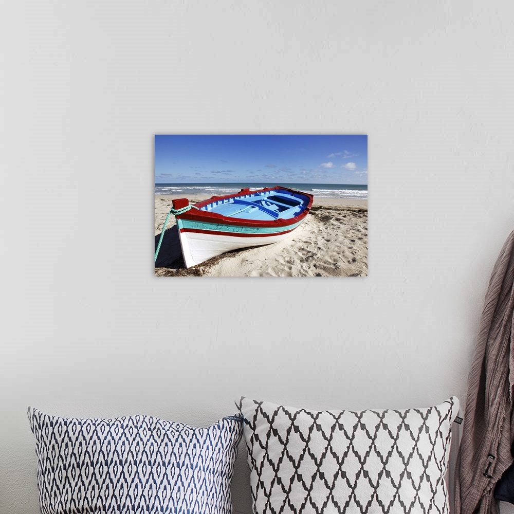 A bohemian room featuring Small  boat on tourist beach the Mediterranean Sea, Djerba Island, Tunisia