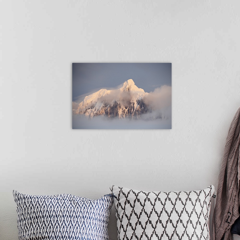 A bohemian room featuring Snow covered mountain at sunset, generating fog cover, Wiencke Island, Antarctica