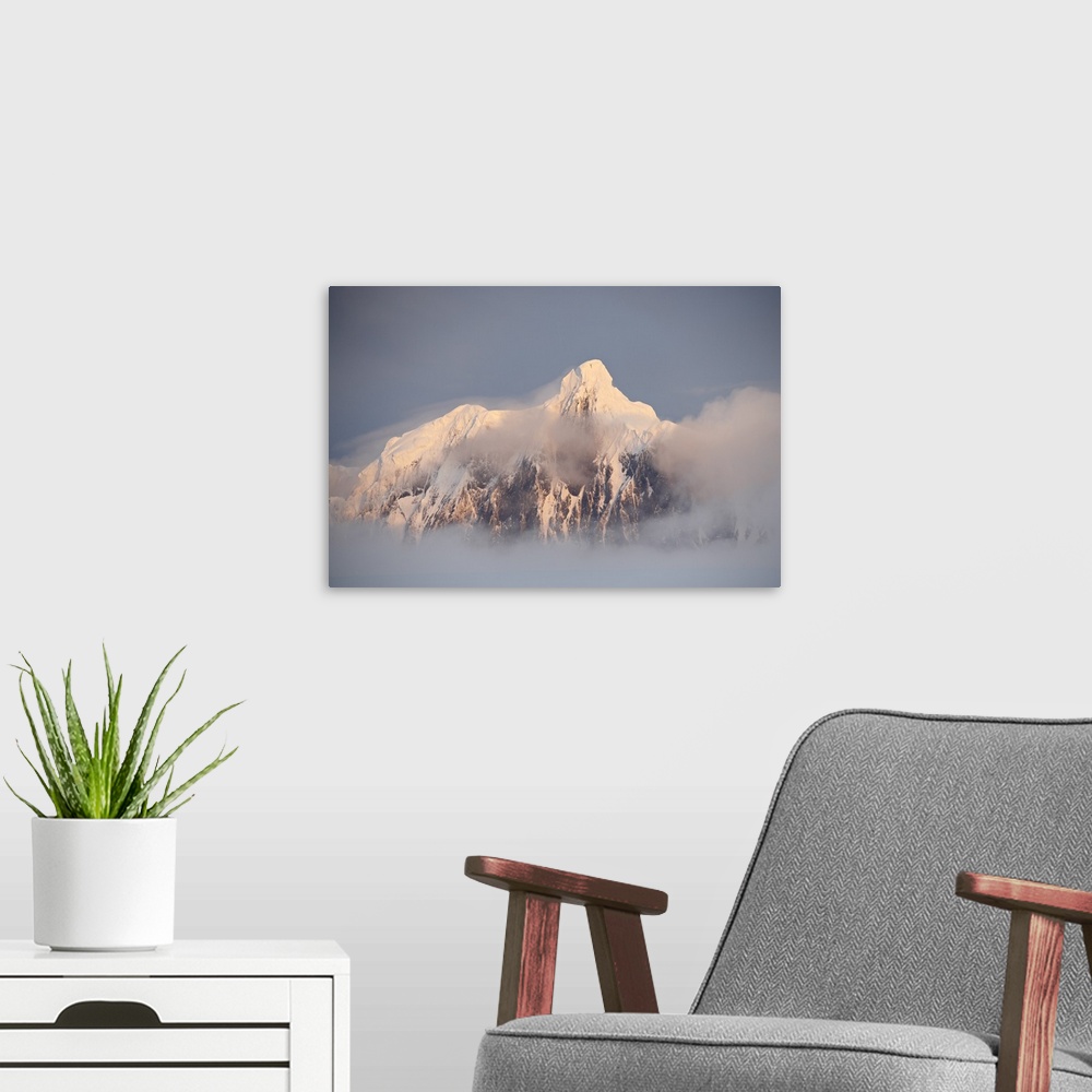 A modern room featuring Snow covered mountain at sunset, generating fog cover, Wiencke Island, Antarctica