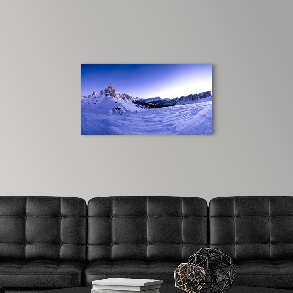 A modern room featuring Pano of snowy Ra Gusela, Cortina d'Ampezzo, Monte Cristallo and Lastoi De Formin at dusk, Giau Pa...