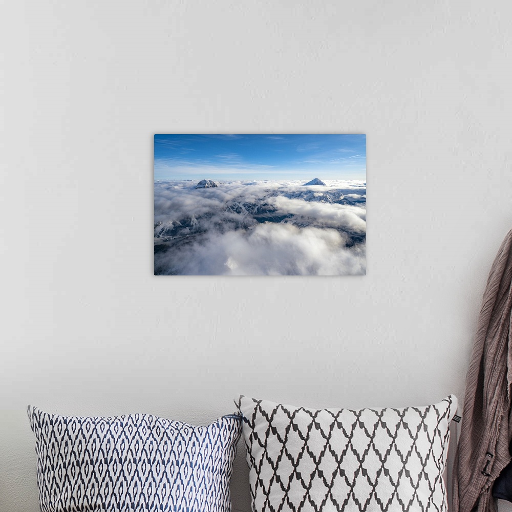 A bohemian room featuring Sorapis group and Antelao emerging from clouds, aerial view, Dolomites, Belluno province, Veneto,...