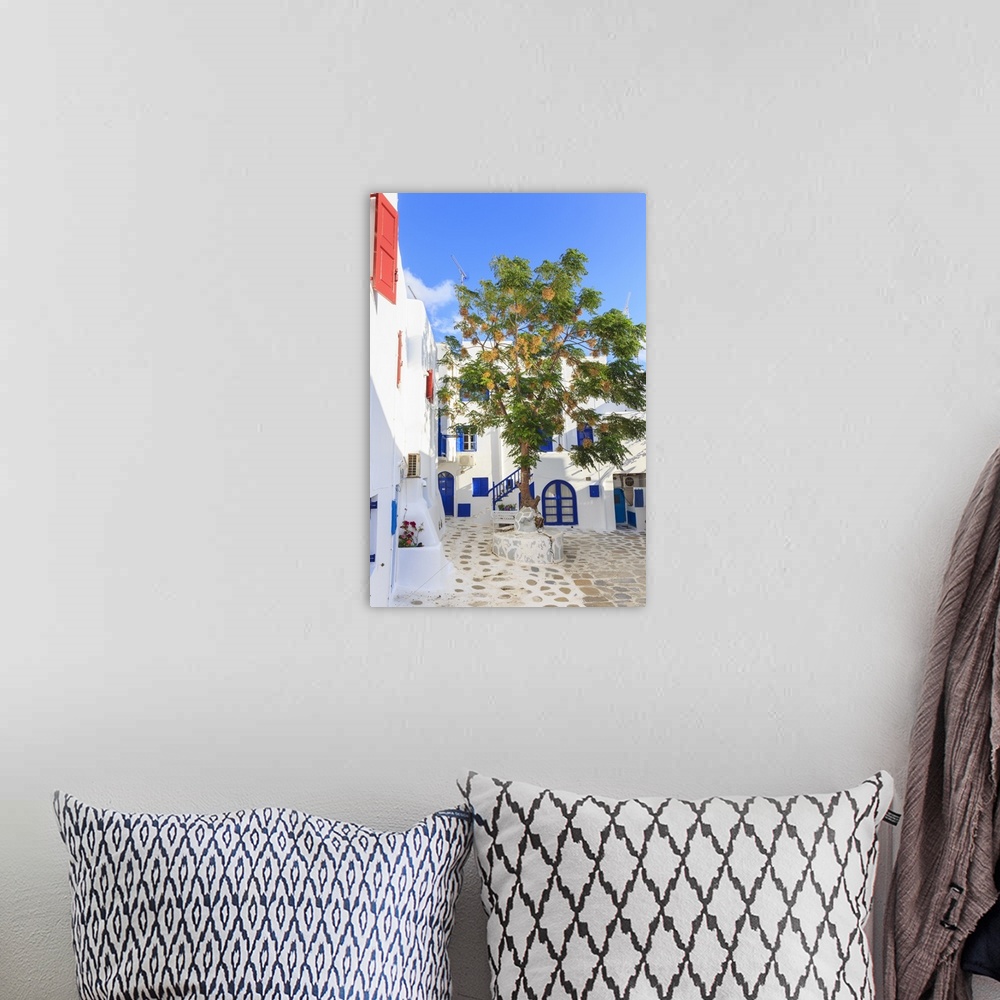 A bohemian room featuring Square with blossoming tree, whitewashed buildings, blue sky, Mykonos Town, Mykonos, Cyclades, Gr...