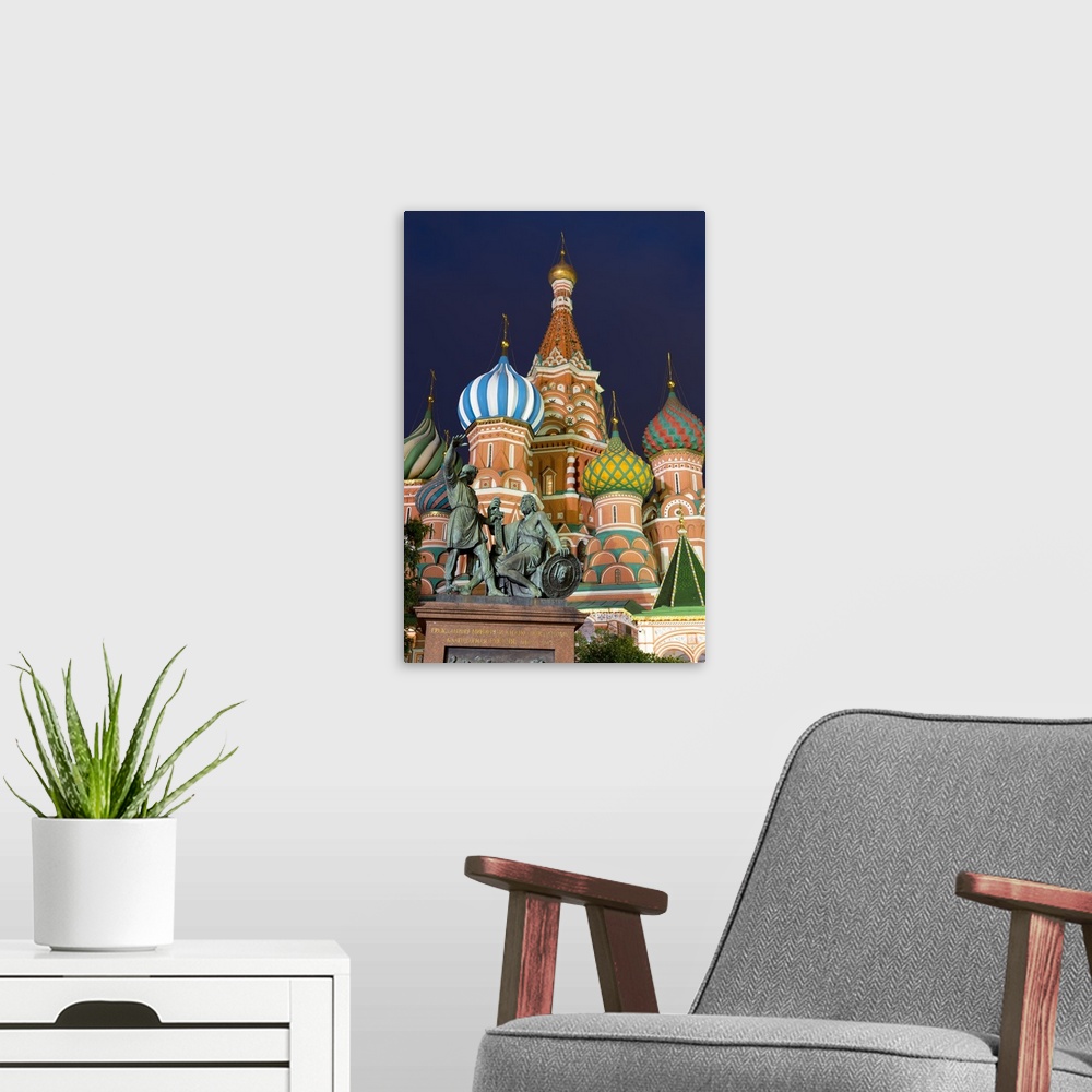 A modern room featuring St. Basil's Cathedral and the statue of Kuzma Minin and Dmitry Posharsky lit up at night, Moscow,...
