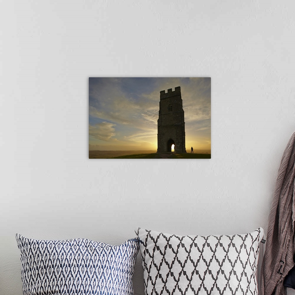 A bohemian room featuring St. Michael's Tower silhouetted at sunset, on the summit of Glastonbury Tor, Glastonbury, Somerse...