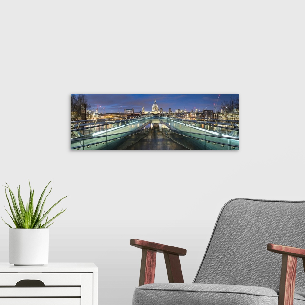 A modern room featuring St. Pauls Cathedral at night, seen across Millennium Bridge, City of London, London, England, Uni...