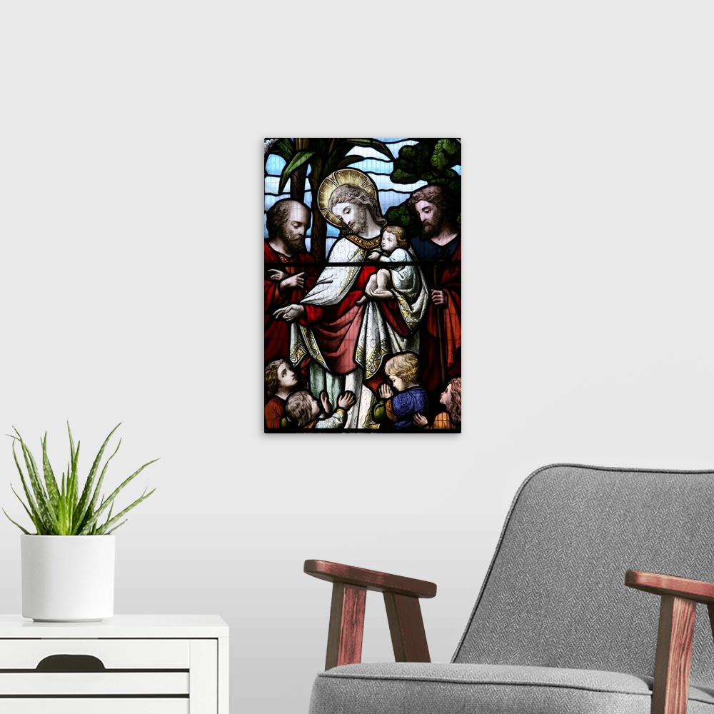 A modern room featuring Stained glass window depicting Jesus welcoming children, Sussex, England, UK