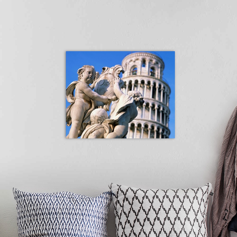 A bohemian room featuring Statues in front of the Leaning Tower in Pisa, Tuscany, Italy