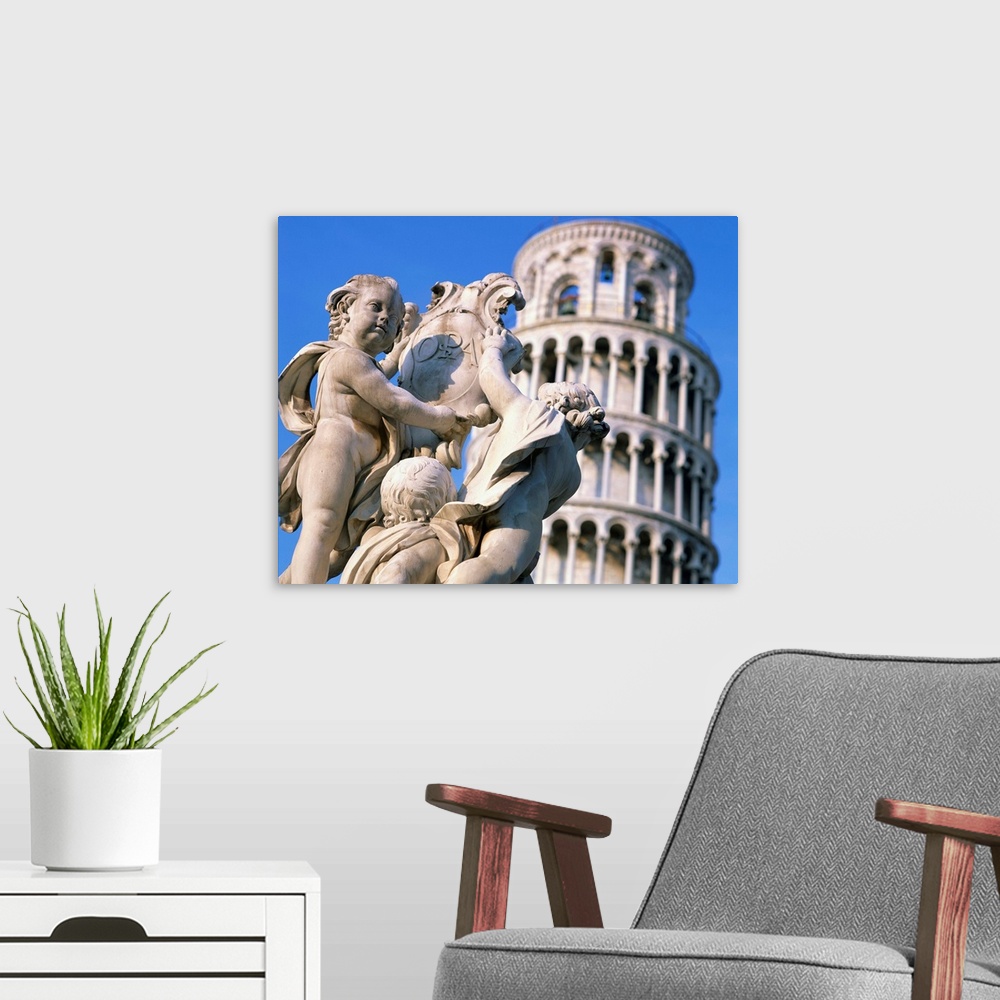 A modern room featuring Statues in front of the Leaning Tower in Pisa, Tuscany, Italy