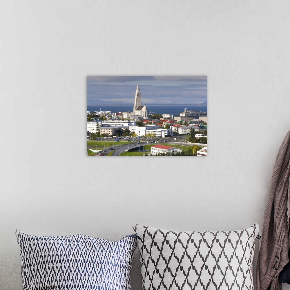 A bohemian room featuring The 75m tall steeple and vast modernist church of Hallgrimskirkja, rising above the city, built b...