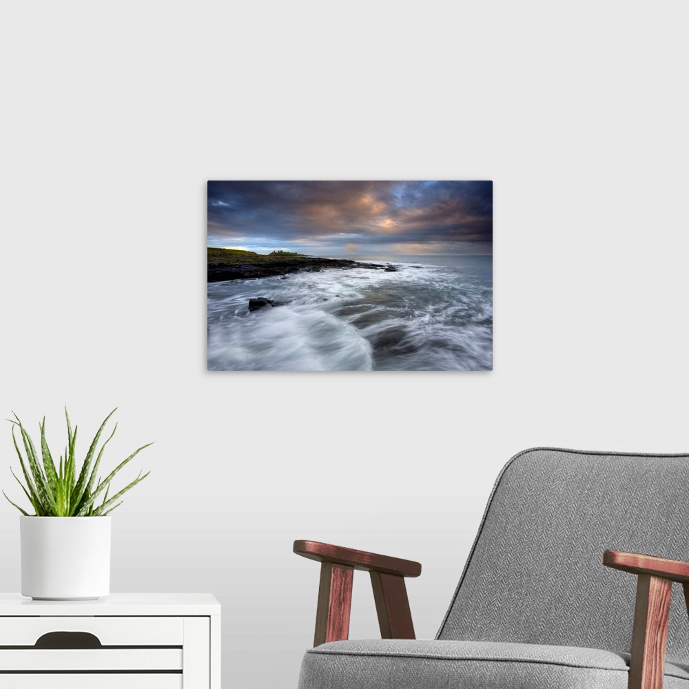 A modern room featuring Stormy day with ruins of Dunstanburgh Castle, Northumberland, England