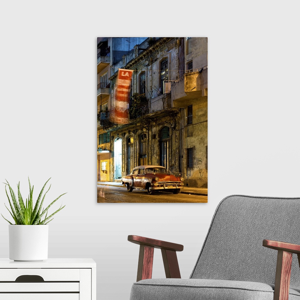 A modern room featuring Street scene at night with vintage American car, Havana Centro, Havana, Cuba