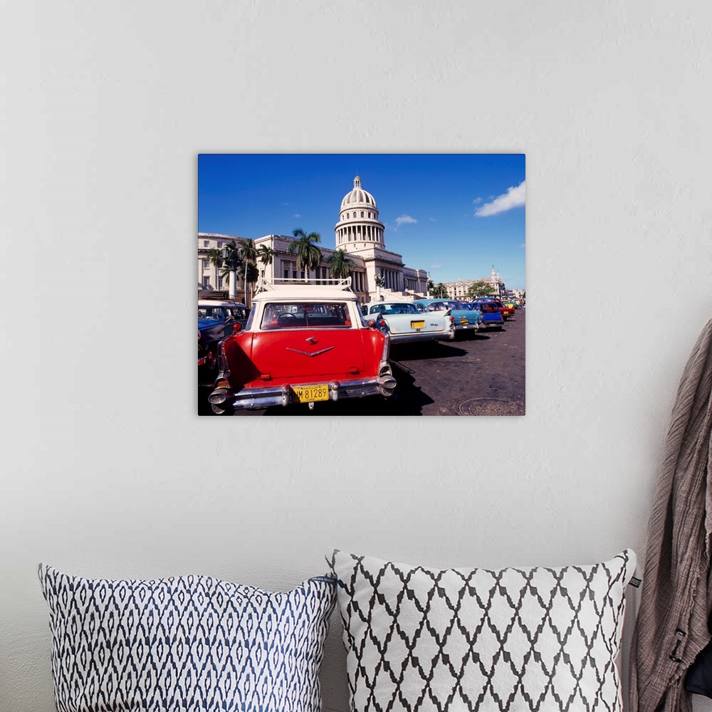 A bohemian room featuring Street scene of taxis parked near the Capitolio Building in Central Havana, Cuba