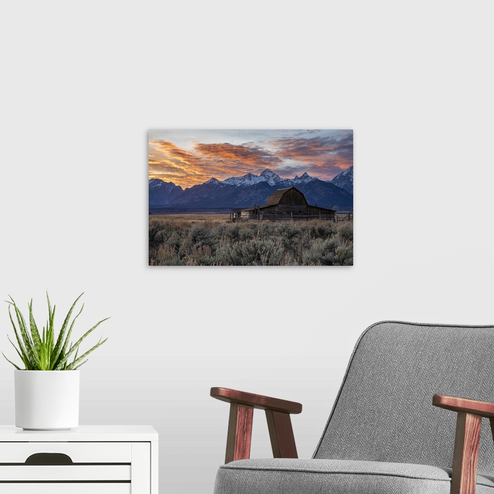 A modern room featuring Sun setting over the Teton Range at Moulton Barn, Grand Teton National Park, Wyoming, United Stat...