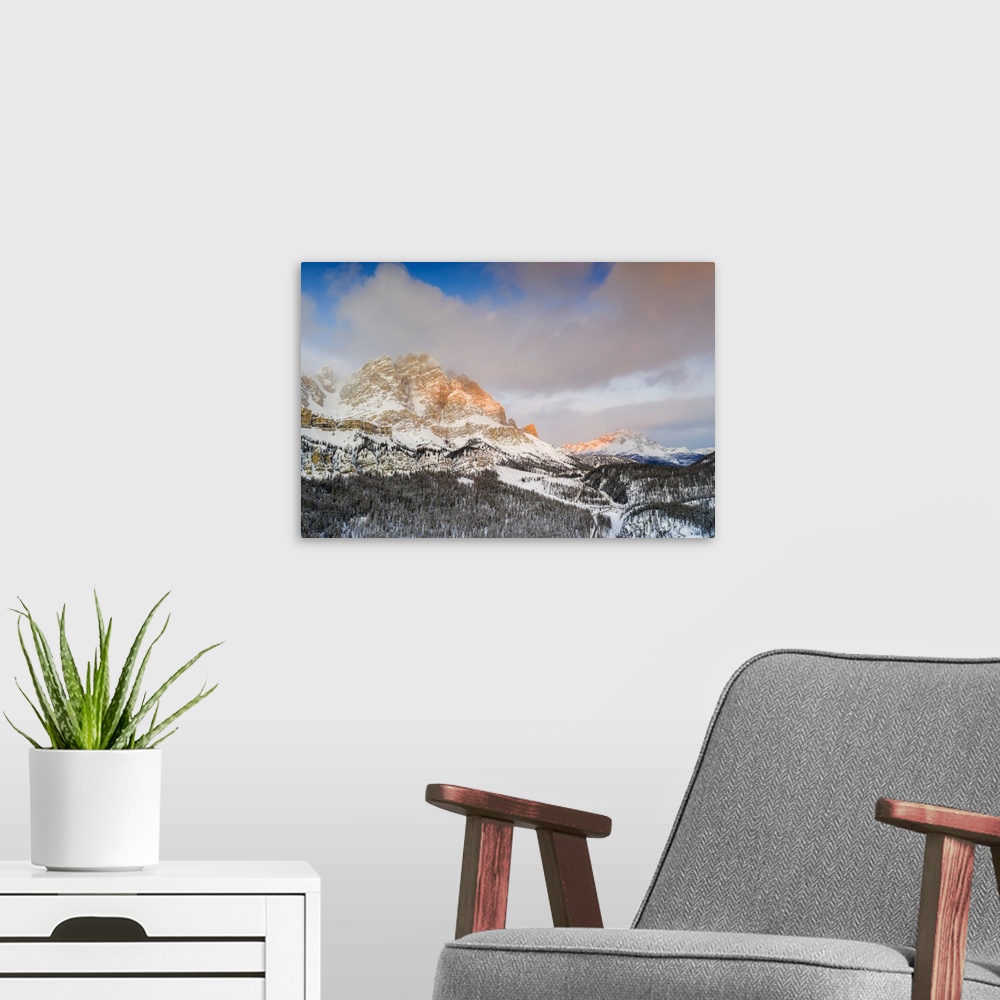 A modern room featuring Sunrise over Monte Cristallo and Passo Tre Croci surrounded by snowy woods, Dolomites, Belluno pr...
