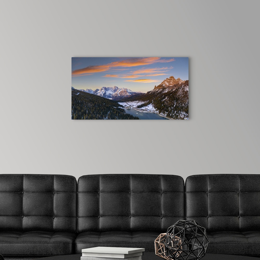 A modern room featuring Sunrise over the snowy woods surrounding Lake Misurina and Sorapis, aerial view, Dolomites, Bellu...