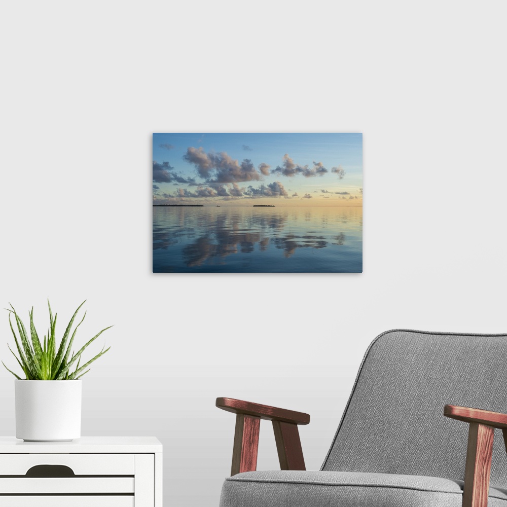 A modern room featuring Sunset over the calm waters of Tikehau, Tuamotus, French Polynesia