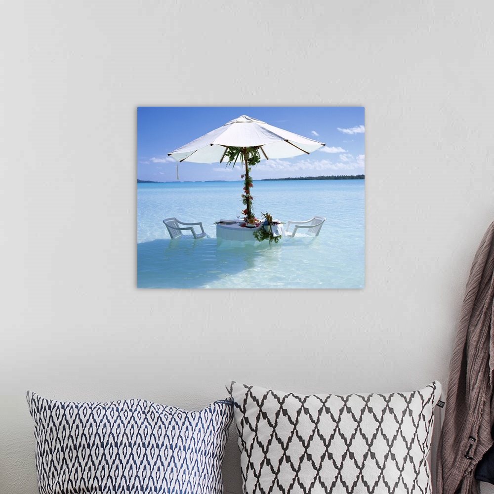 A bohemian room featuring Table, chairs and parasol in the ocean, Bora Bora Tahiti, French Polynesia