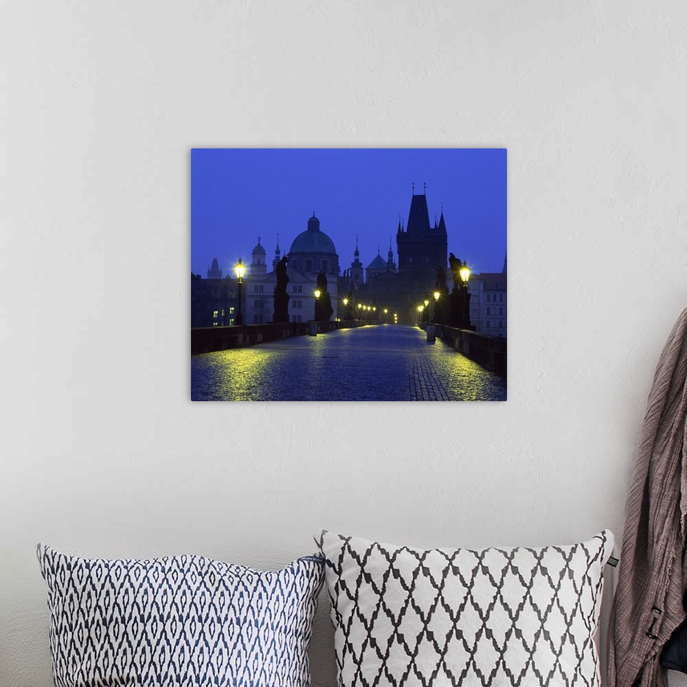A bohemian room featuring The Charles Bridge at night and city skyline with spires, Prague, Czech Republic