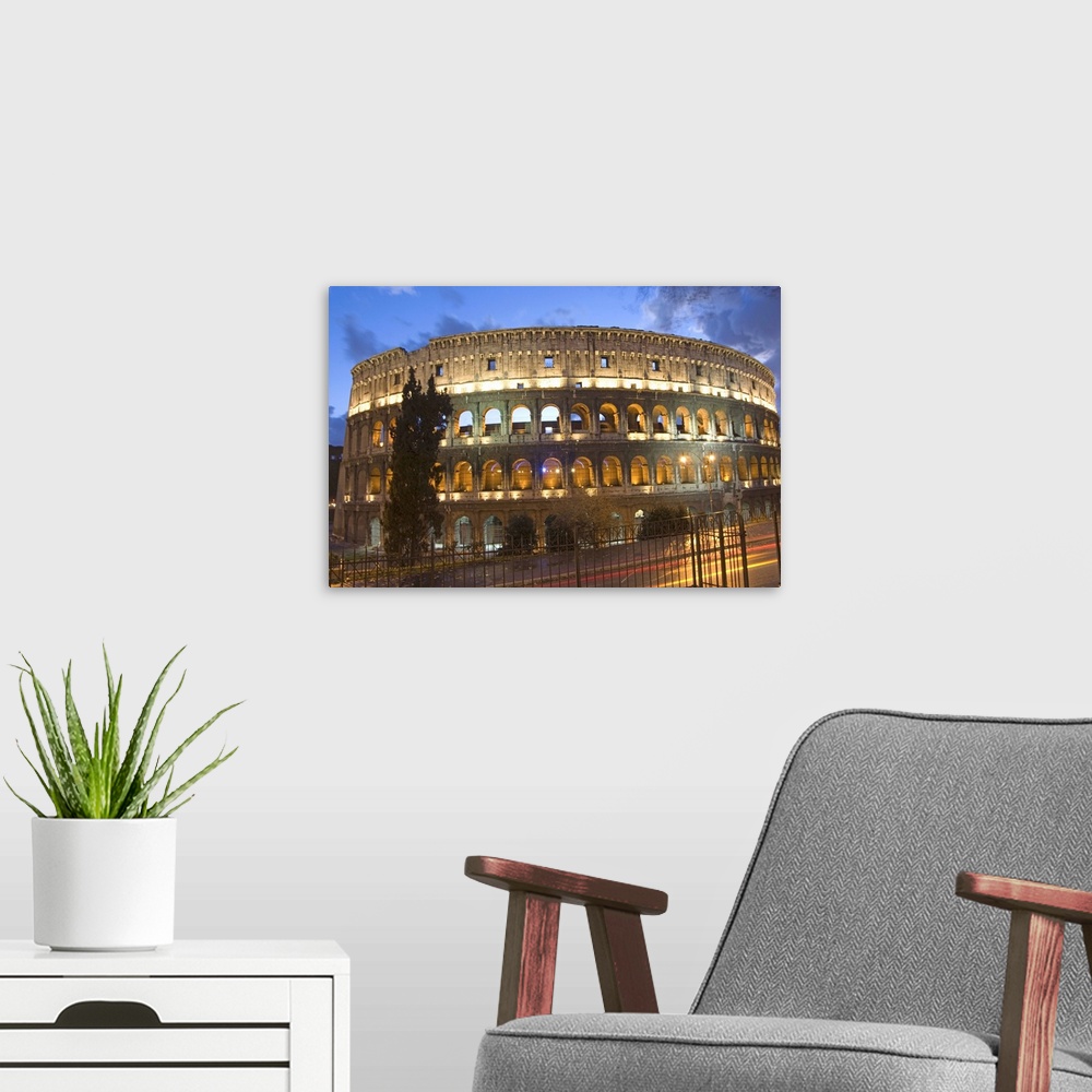 A modern room featuring The Colosseum at night with traffic trails, Rome, Lazio, Italy