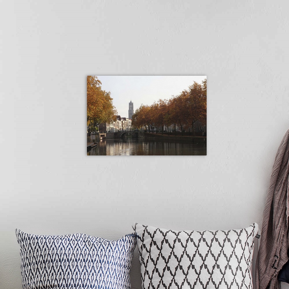 A bohemian room featuring The Dom Tower and canal waterway on an autumn day, Utrecht, Netherlands