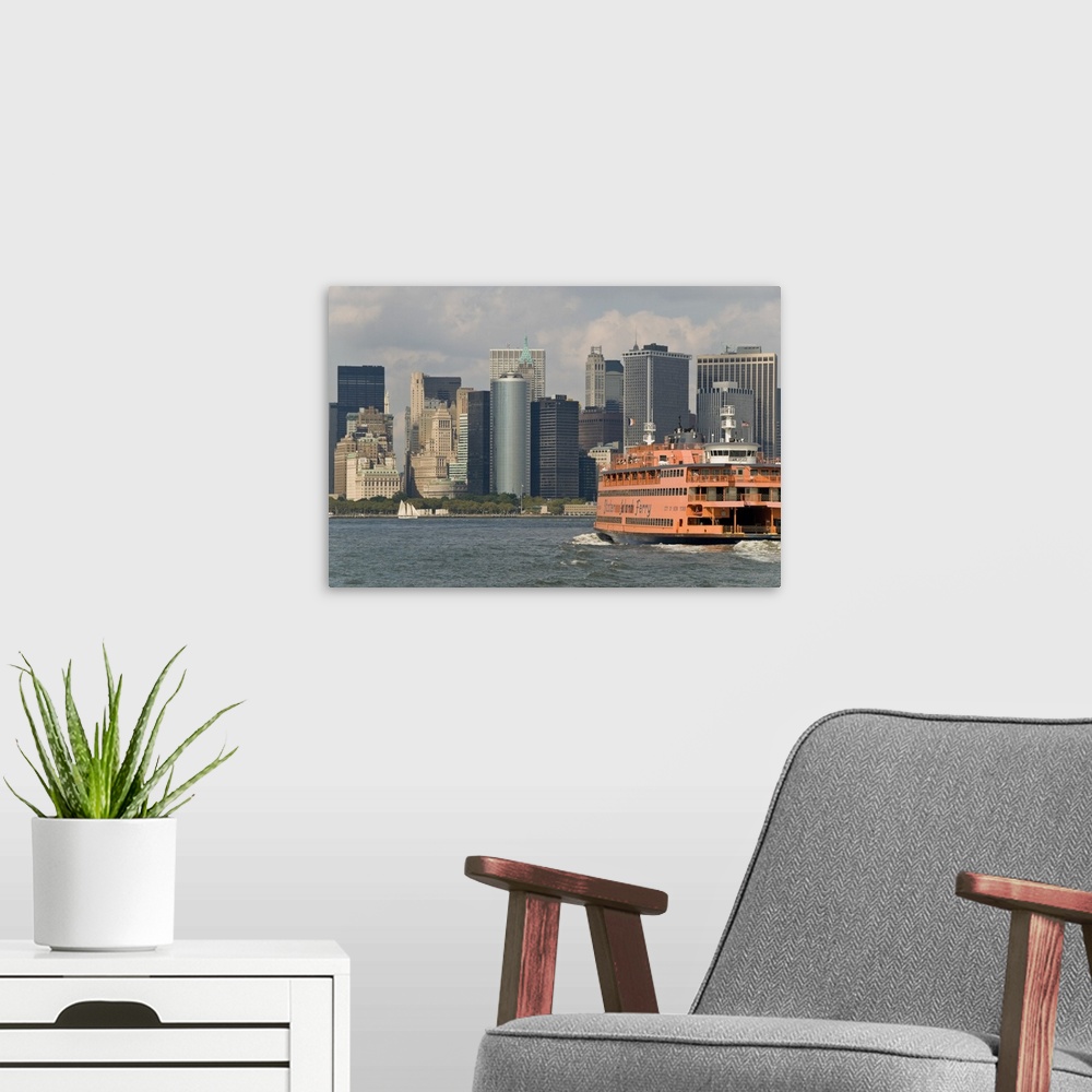 A modern room featuring The famous orange Staten Island Ferry approaches lower Manhattan, New York