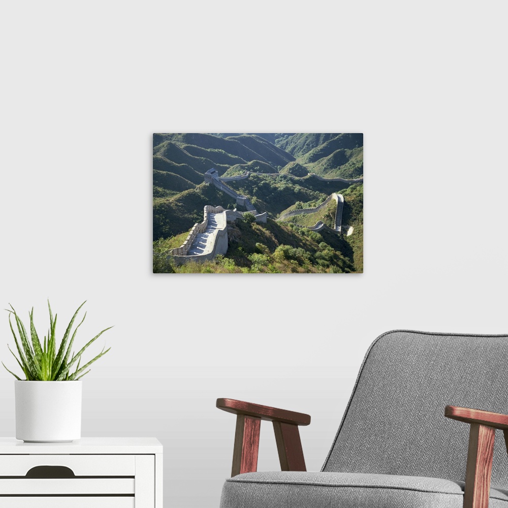 A modern room featuring The Great Wall of China snaking through the hills, China, Asia