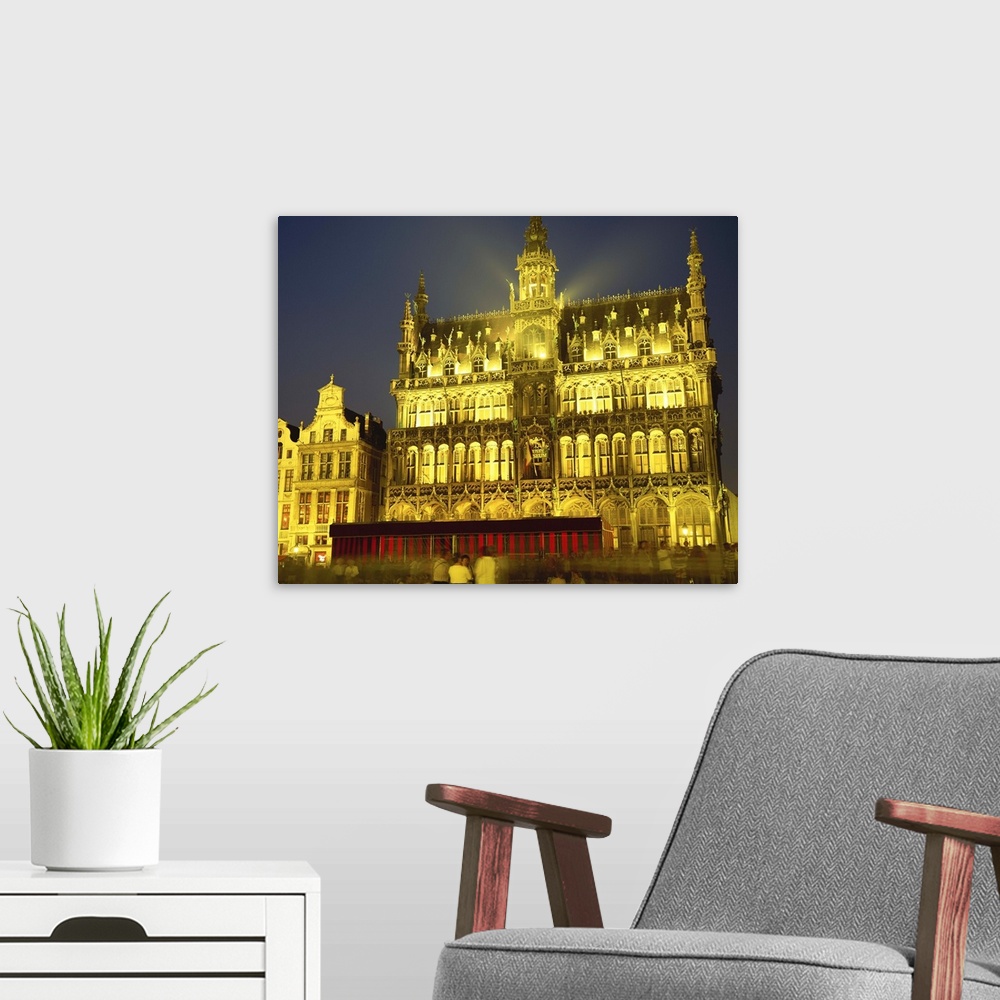 A modern room featuring The Museum floodlit at night in the Grand Place in Brussels, Belgium