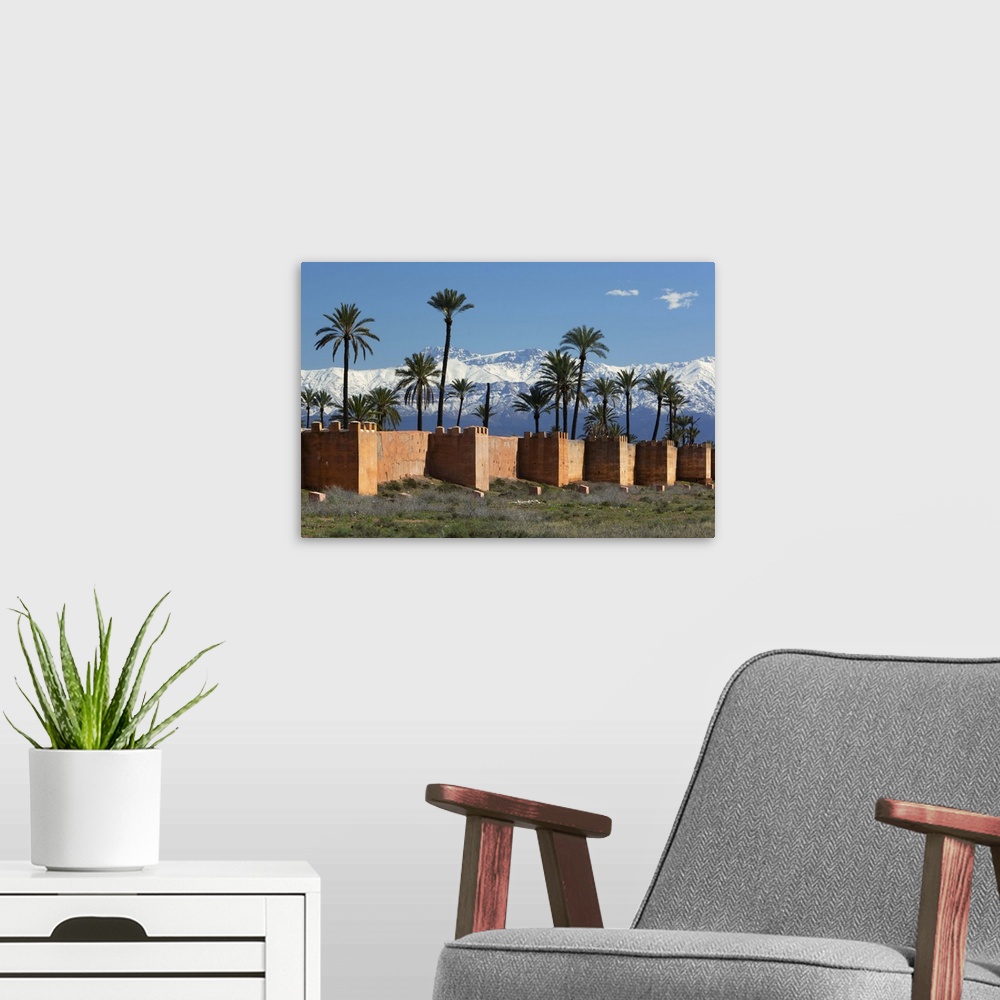 A modern room featuring The old city walls and snow capped Atlas Mountains, Marrakech, Morocco, North Africa, Africa.