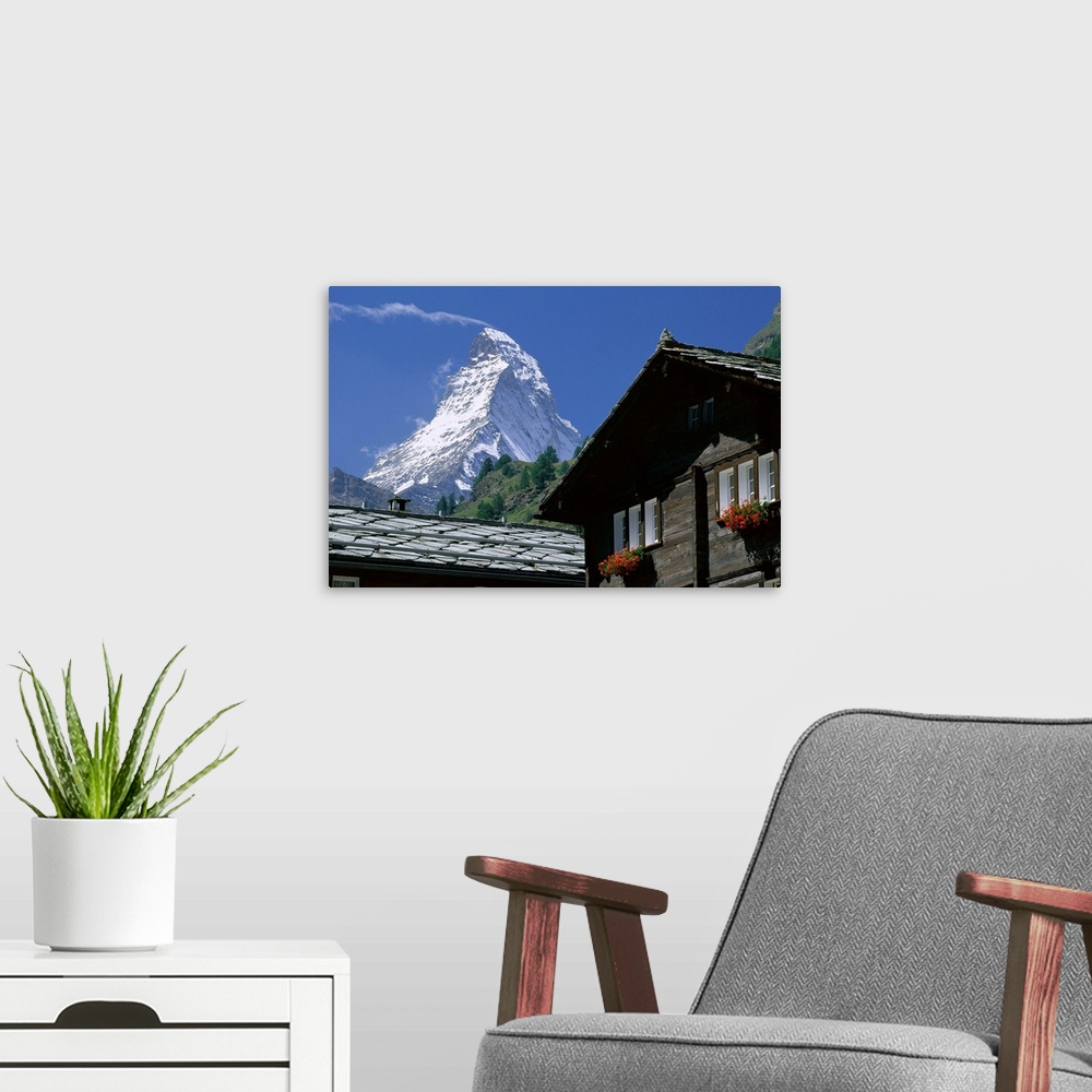 A modern room featuring The peak of the Matterhorn mountain towering above chalet rooftops, Zermatt, Valais, Swiss Alps, ...