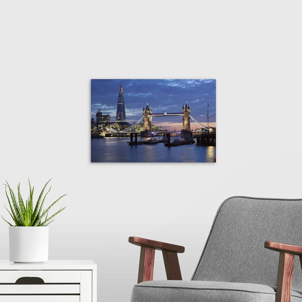 A modern room featuring The Shard and Tower Bridge on the River Thames at night, London, England, United Kingdom, Europe.